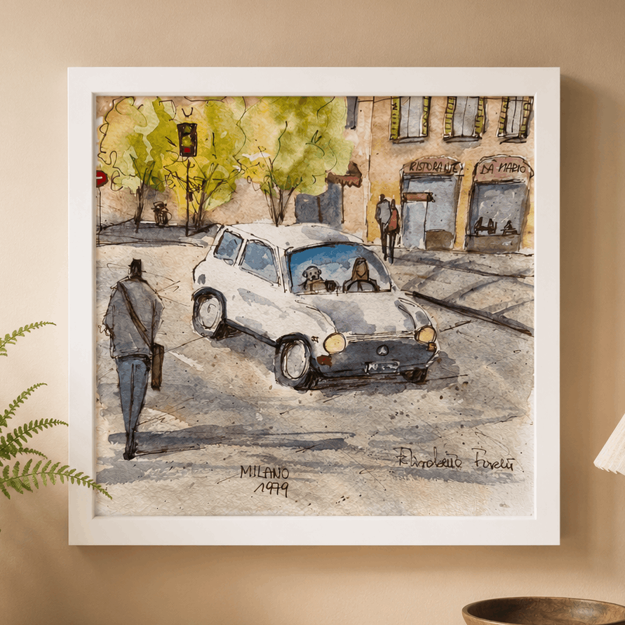 Framed artwork of a city street scene Milan with a car and people, displayed on a wall above a wooden surface with decor items.
