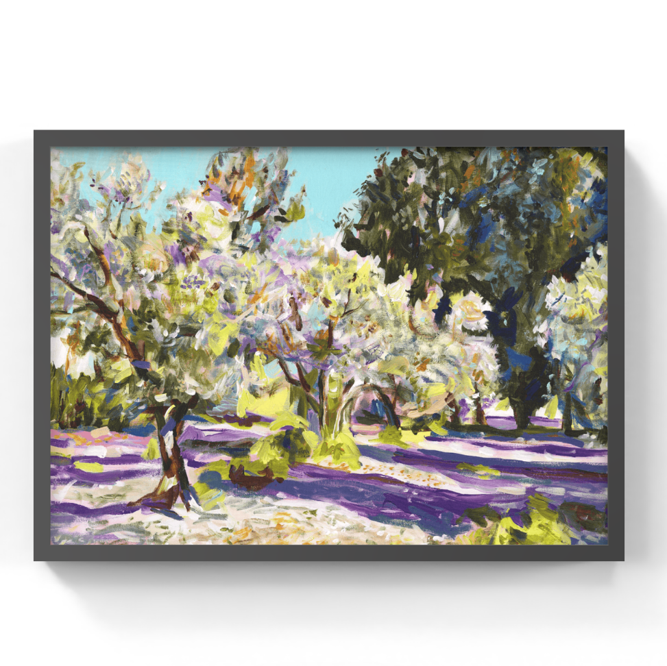 A framed painting of an olive grove with blooming white and purple trees under a light blue sky, displayed on a clean white wall.