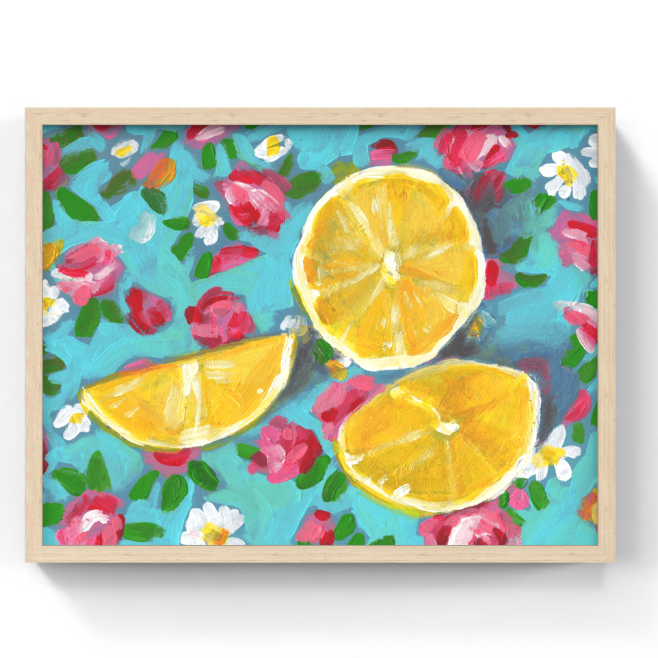 A framed painting featuring three yellow lemon slices on a turquoise background with pink and white flowers and green leaves, shown against a plain white wall.