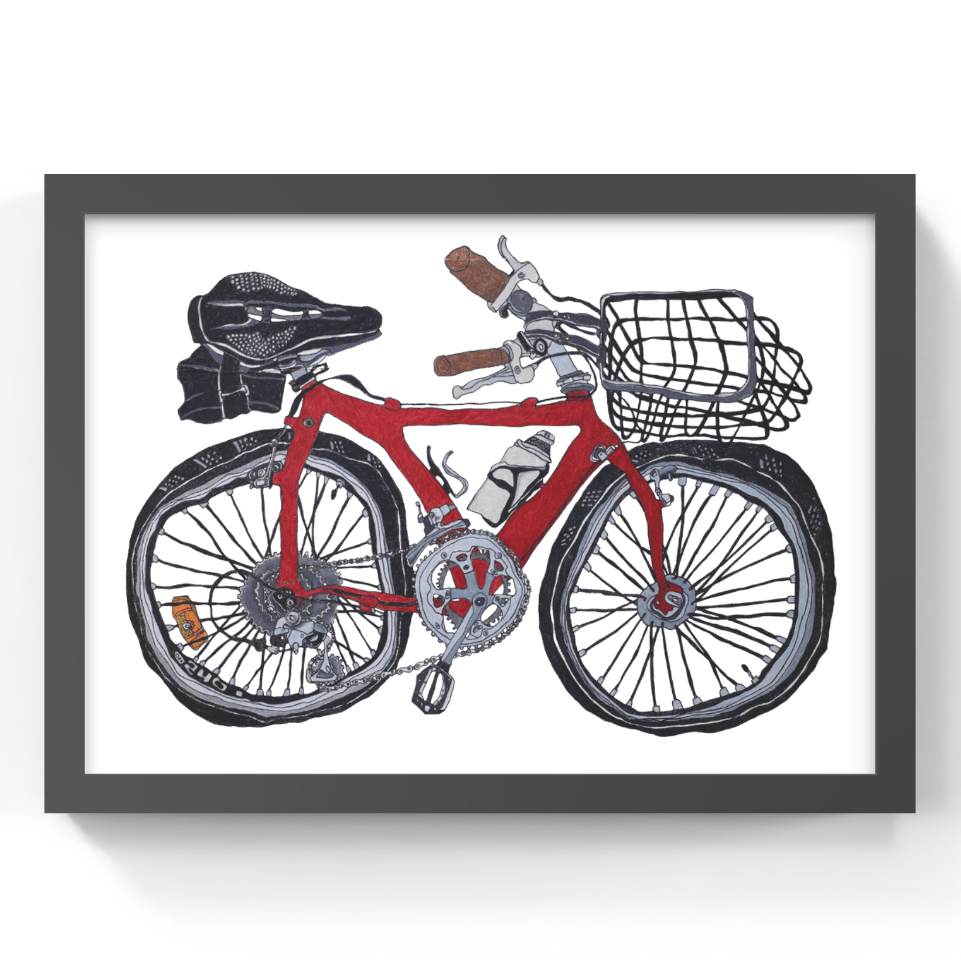 A framed art print featuring a hand-drawn illustration of a red bicycle with a black basket, saddle, and tires, set against a white background with a dark gray frame.