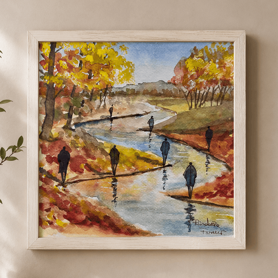 Framed painting of a autumn landscape with people walking by a river on a wall above a wooden shelf.