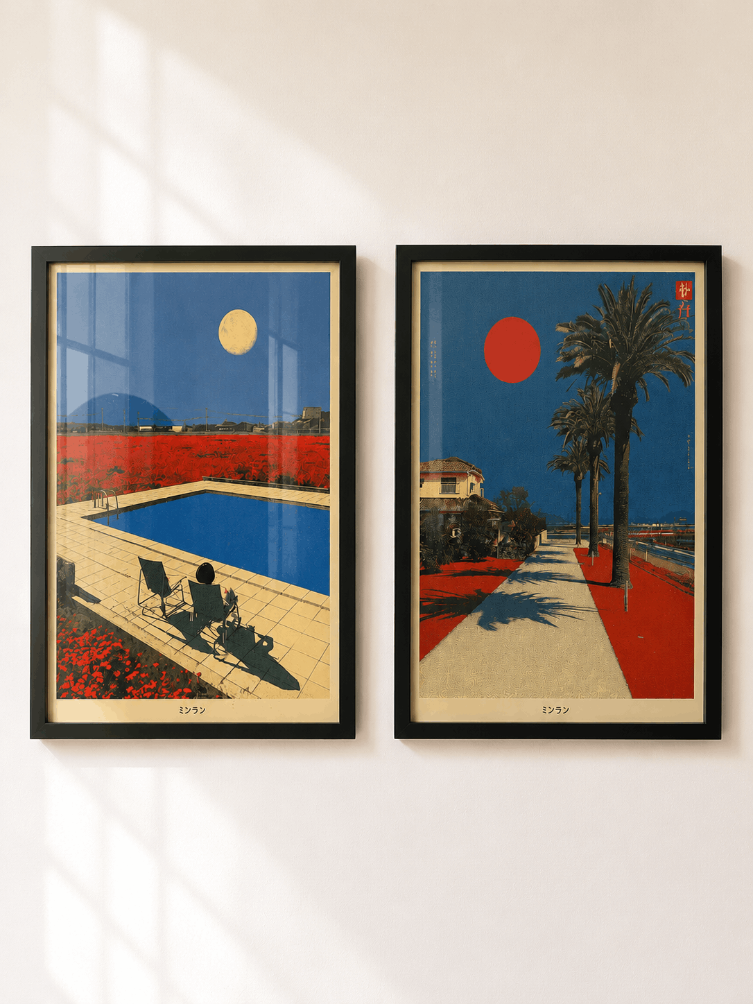 Two framed art prints with black frames hang side-by-side on a white wall. The left print depicts a modern swimming pool with a person sitting by it, surrounded by red poppy fields under a yellow sun.